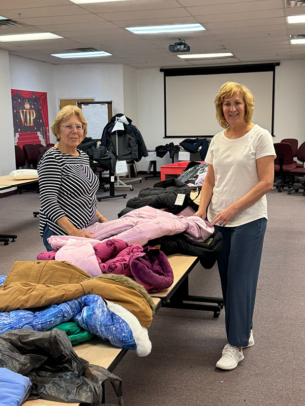 MWA Members sorted through donations and prepared for the delivery of winter coats to the homeless and needy